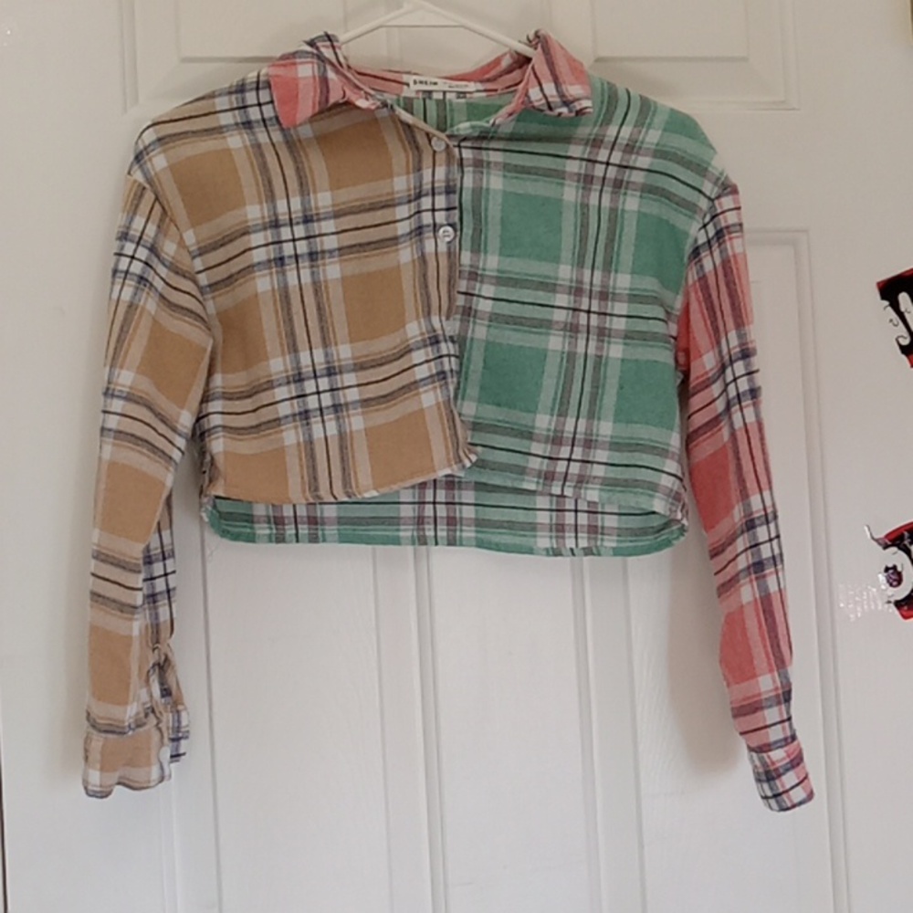 This shirt is green pink and cream. It is from the brand SHEIN.